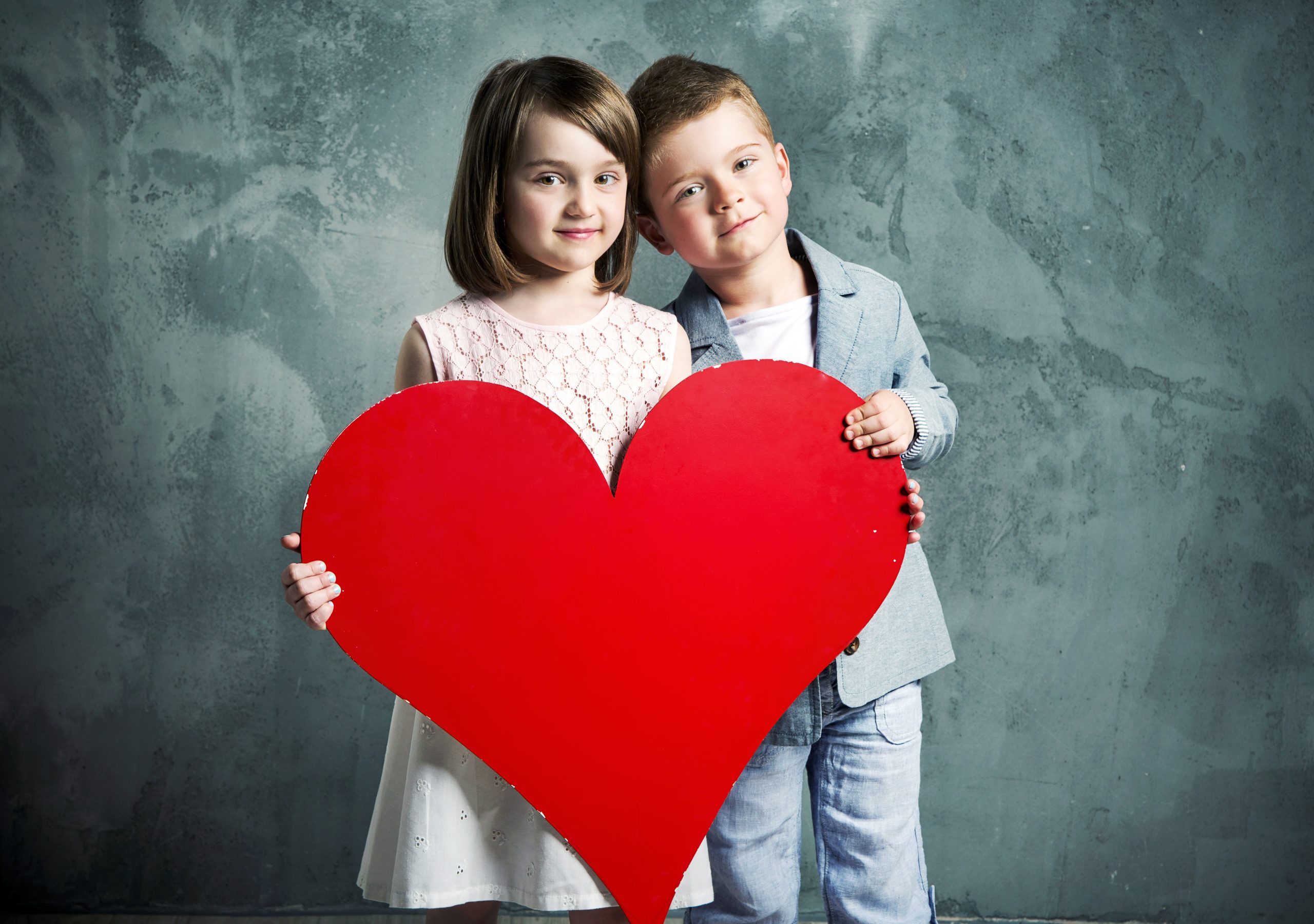 Two kids holding a giant heart